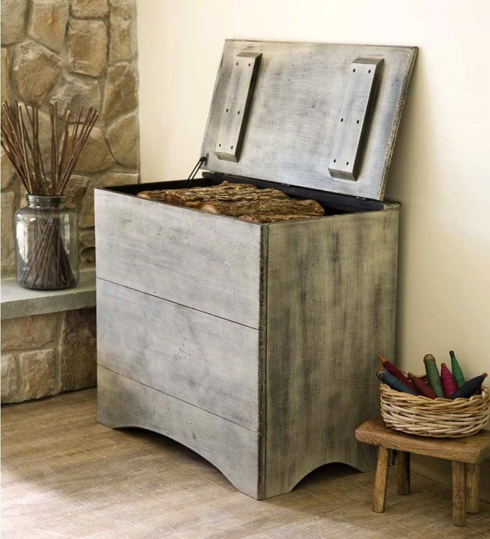 an old chest sitting on the floor next to a basket