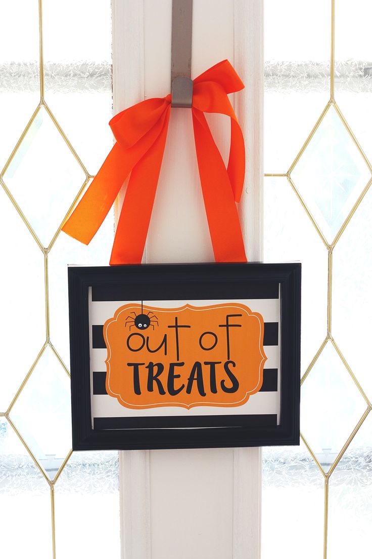 a sign that says out of treats hanging on a door