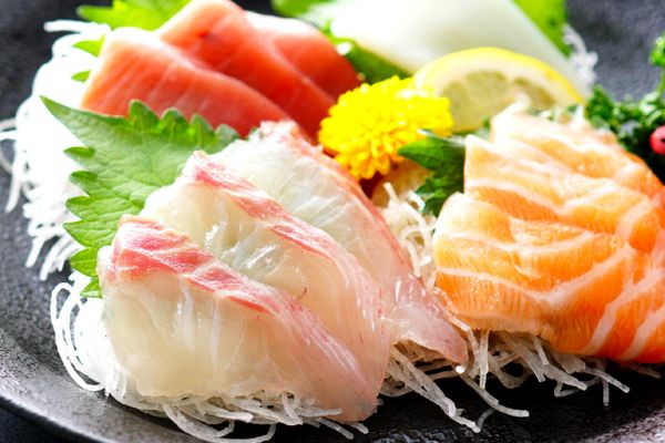 a black plate topped with different types of sushi