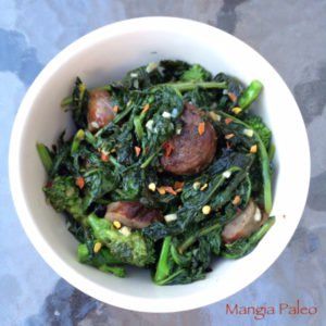 a white bowl filled with broccoli and meat on top of a blue table