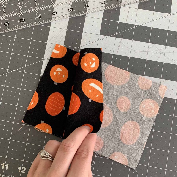 two pieces of fabric with pumpkins on them are being sewn together to make an applique