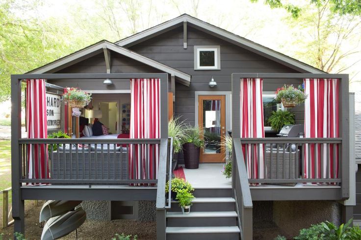 a small house with red and white striped curtains