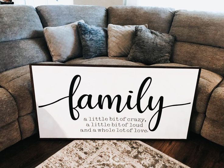 a family sign sitting on the floor next to a couch