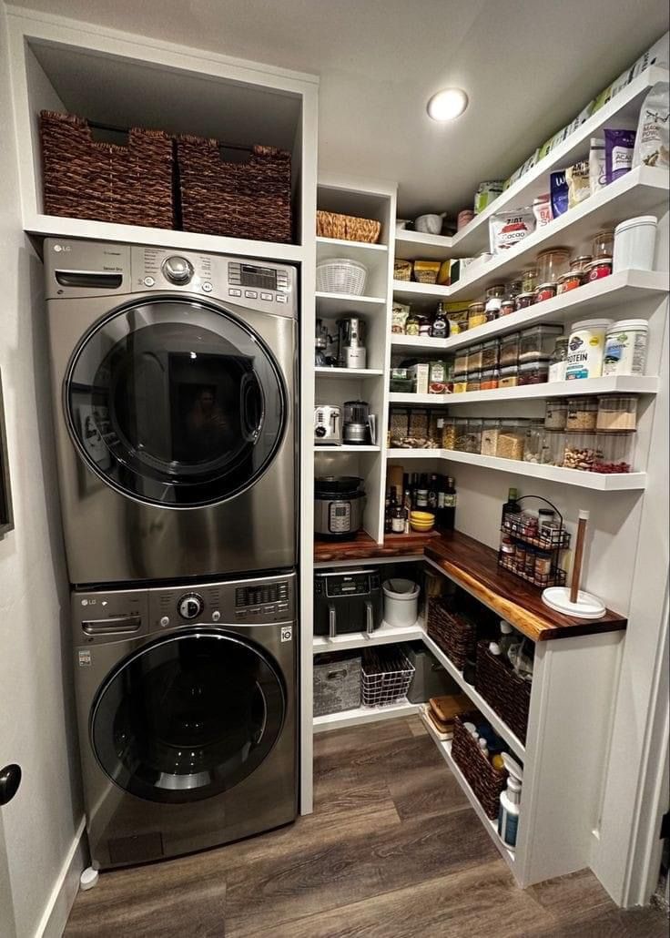 a large washer and dryer in a small room with open shelvings