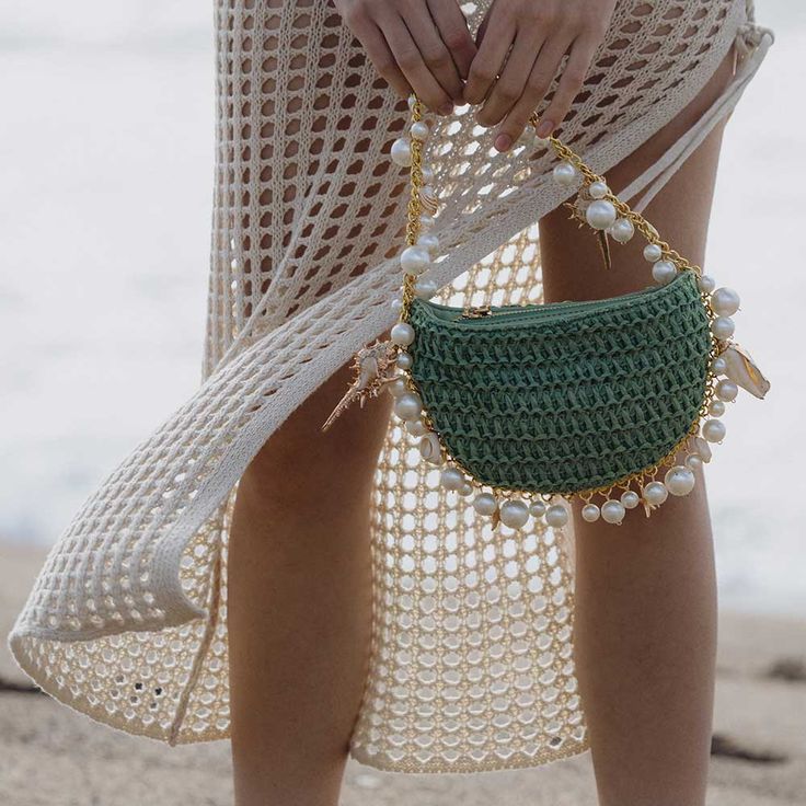 Introducing the Isla top handle bag, the perfect addition to your summer accessories. Made with a hand woven straw and detailed with pearl and seashells along its silhouette giving Isla an elegant look. This bag includes a spacious interior perfect for your everyday essentials. Hand Woven Straw 9" W x 5.25" H x 1"D Handle Drop: 6" Zipper Closure Gold-Tone Hardware OEKO-TEX Certified Lining Fits up to an iPhone 14 Pro Product No.YN7533NT Melie Bianco, Large Shoulder Bags, Face Products Skincare, Top Handle, Summer Accessories, Uganda, Trinidad And Tobago, Face And Body, Crochet Bag