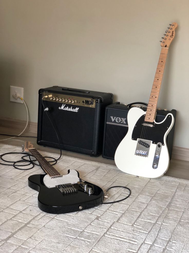 an electric guitar and amp are sitting on the floor