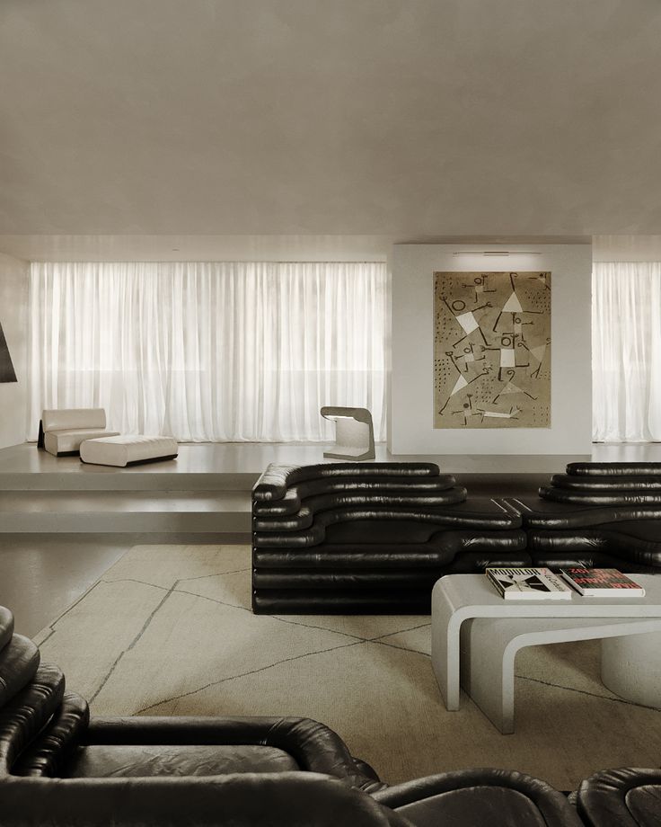 a living room filled with black leather furniture