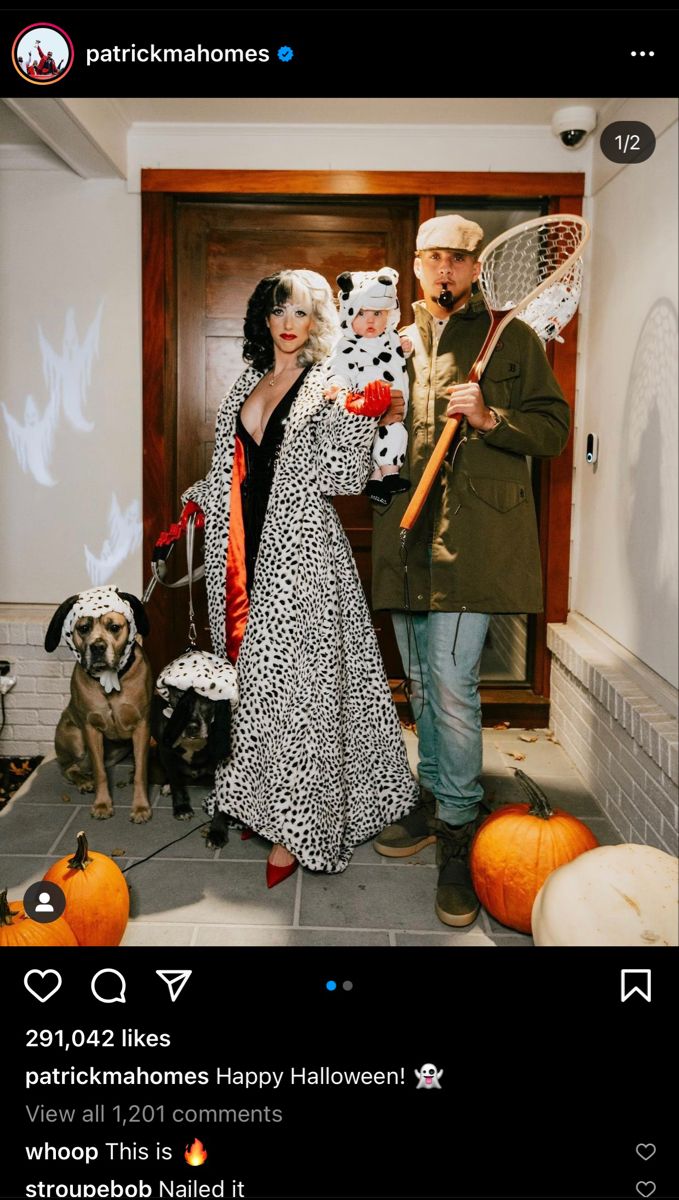 a man and woman dressed up in costumes with dogs on leashes standing next to each other