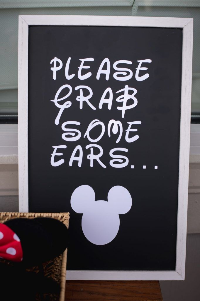 a sign that says please grab some ears on the side of a table with a red and white polka dot hat