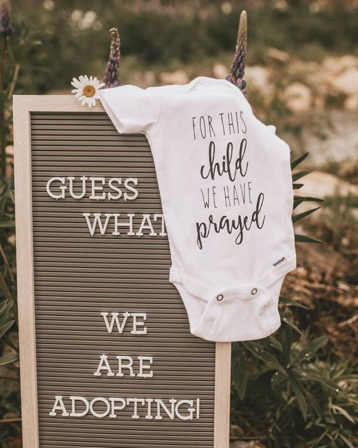 a sign that says, for this child we are praying with a white shirt on it