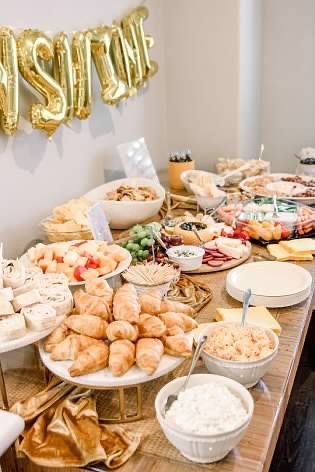 a table filled with lots of food and balloons