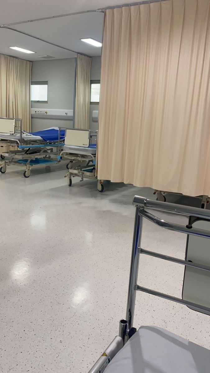 an empty hospital room with medical equipment in it