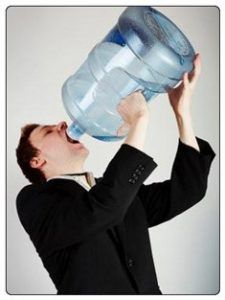 a woman is drinking from a large plastic water bottle with caption that reads, flushing ketones