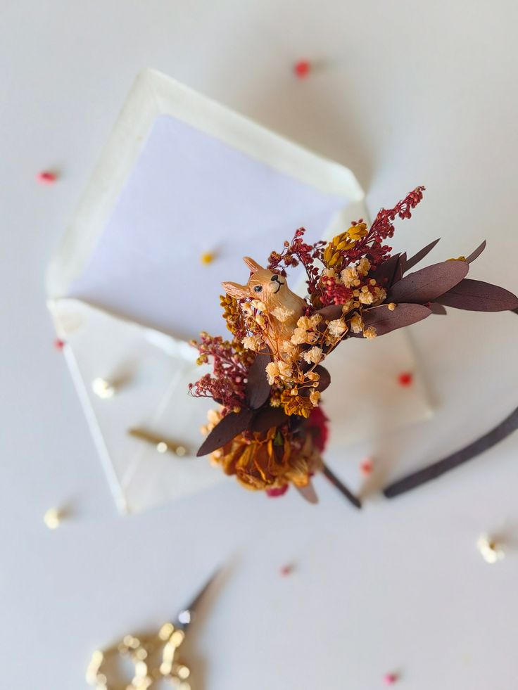 a close up of a flower on top of a white table with confetti