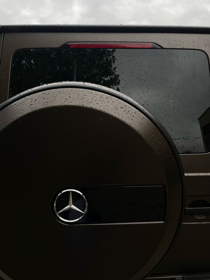 the back end of a vehicle with raindrops on it