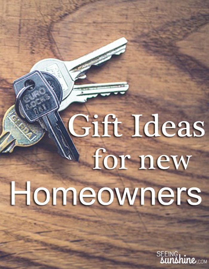 the words gift ideas for new homeowners are shown above two keys on a wooden surface