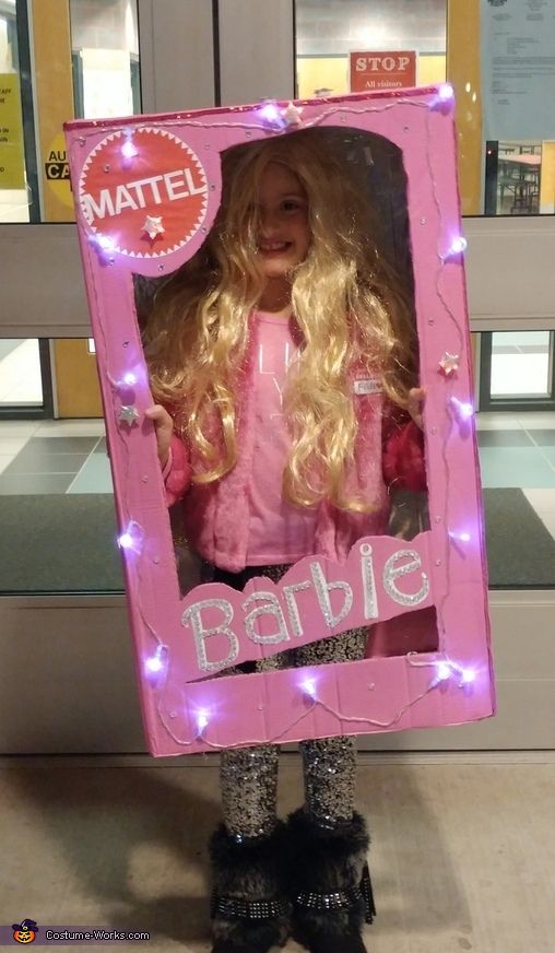 a barbie doll in a pink box with lights on it's head and legs