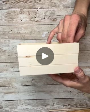 a person holding a piece of wood with the video below it that shows how to make a wooden box