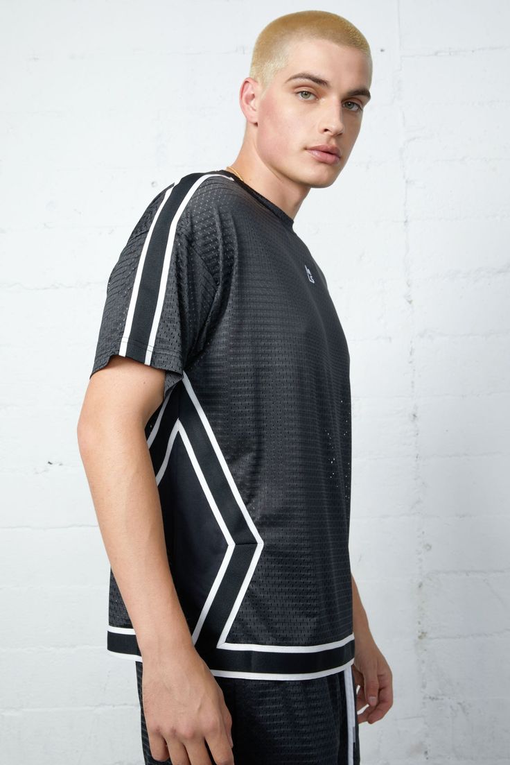 Introducing the Barracuda Mesh Basketball Boxy Tee, perfect for any basketball enthusiast. With a breathable mesh material and a boxy cut, this shirt provides maximum comfort on and off the court. Body: 87% Polyester 13% Spandex Lining: 86% Polyester 14% Cotton Models are 6'2" and wearing a size medium Short Vest, Sweater Jumpsuit, Boxy Tee, Crochet Tank, Mesh Material, Romper Dress, The Court, Tight Leggings, Skirt Pants