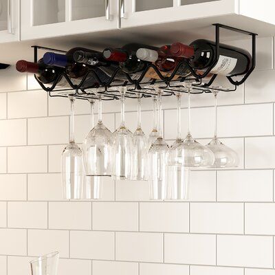 several wine glasses are hanging from the wall