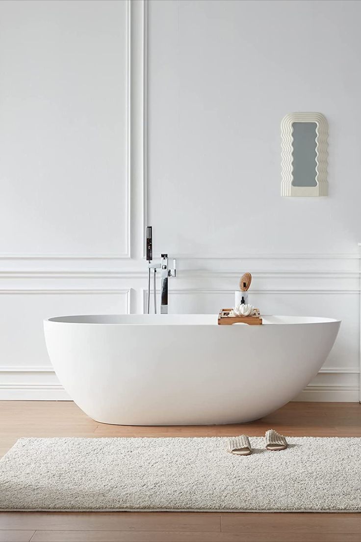 a large white bath tub sitting on top of a wooden floor