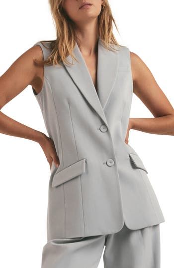 Full of structure and polish, this longline blazer-vest is ideal from desk to dinner. 30" length (size Medium) Front button closure Peaked lapels Front flap pockets Lined 63% polyester, 32% rayon, 5% spandex Dry clean Imported Formal Fall Vest With Notch Lapel, Formal Notch Lapel Vest For Fall, Spring Vest With Notch Lapel And Welt Pockets, Elegant Vest With Lapel Collar For Work, Formal Spring Vest With Welt Pockets, Fitted Chic Vest With Welt Pockets, Chic Fitted Vest With Welt Pockets, Notch Lapel Vest With Button Closure For Office, Office Vest With Notch Lapel And Button Closure