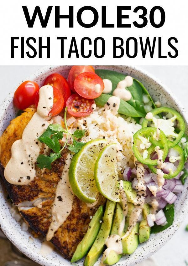 a white bowl filled with fish taco bowls and garnished with avocado