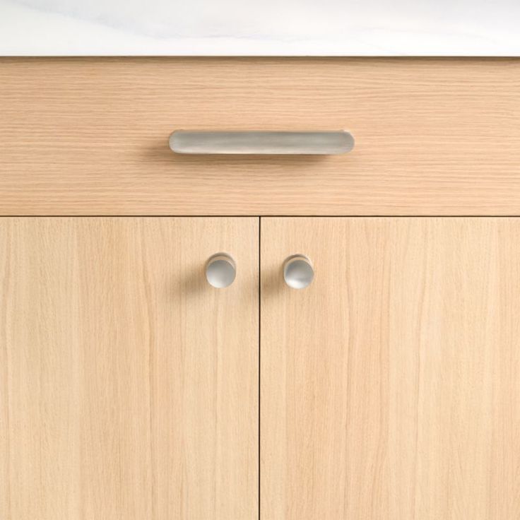 a cabinet with two doors and knobs on it