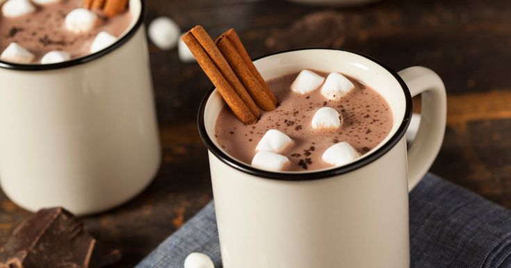 two mugs filled with hot chocolate and marshmallows