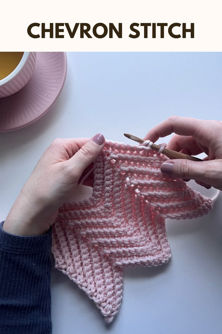 someone crocheting a piece of pink yarn with the words chevron stitch on it