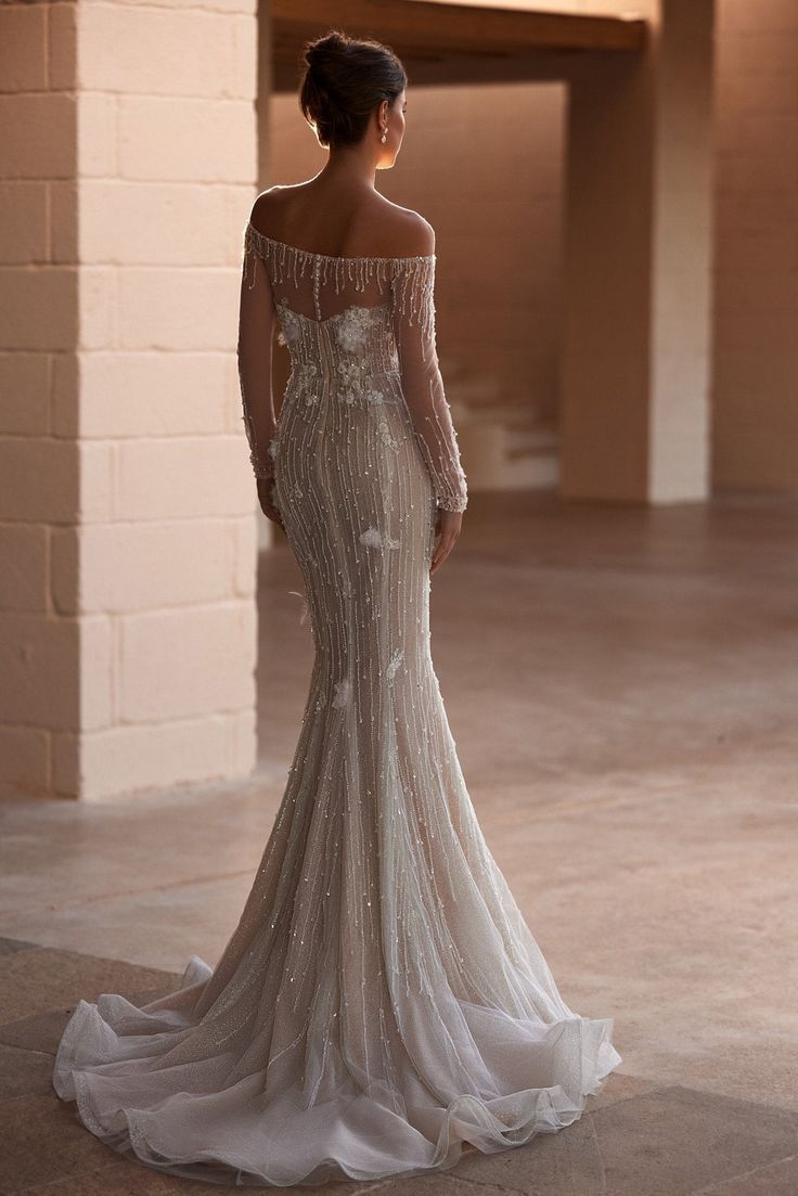 Discover the epitome of bridal elegance with our "Elegant Off-the-Shoulder Beaded Bridal Gown with Over Skirt and Luxurious Train Plus Size". This breathtaking gown features a delicately beaded off-the-shoulder corset that highlights your shoulders and frames the natural beauty of your neckline. The fitted bodice seamlessly transitions into a stunning over skirt, adding a layer of sophistication and grandeur. Crafted with meticulous attention to detail, the luxurious train cascades gracefully, c Glamorous Off-shoulder Wedding Gown, Elegant Off-shoulder Reception Dress, Off-shoulder Embellished Wedding Gown, Glamorous Off-shoulder Wedding Ball Gown, Embellished Off-shoulder Evening Dress For Wedding, Off-shoulder Wedding Dress With Detachable Train, Off-shoulder Evening Dress With Detachable Train For Wedding, Off-shoulder Wedding Gown With Sweep Train, Off-shoulder Evening Dress With Sweep Train For Wedding