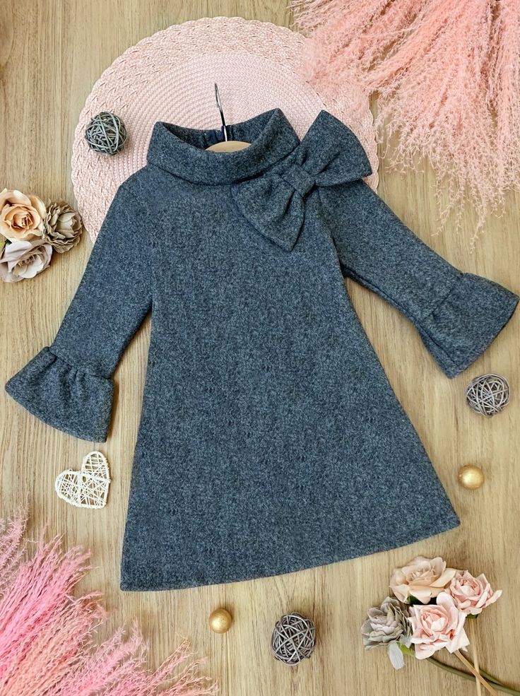 This dress is so Fall-ishously simple and stylish. It's made of soft fabric, perfect for those cozy winter days, and a unique wide turtle neck. It has a beautiful bow and 3/4 ruffled sleeves Perfect for back to school, Fall, birthday parties, and year-round play Soft cotton blend is soft on her skin and allows for stre Girls Long Sleeve Dresses, Fall School, Girls Dress Outfits, Toddler Flower Girl Dresses, Infant Flower Girl Dress, Tea Party Dress, Baby Outerwear, Winter Birthday