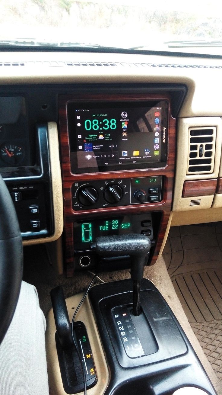 the dashboard of a car with an electronic device in it's center console and radio