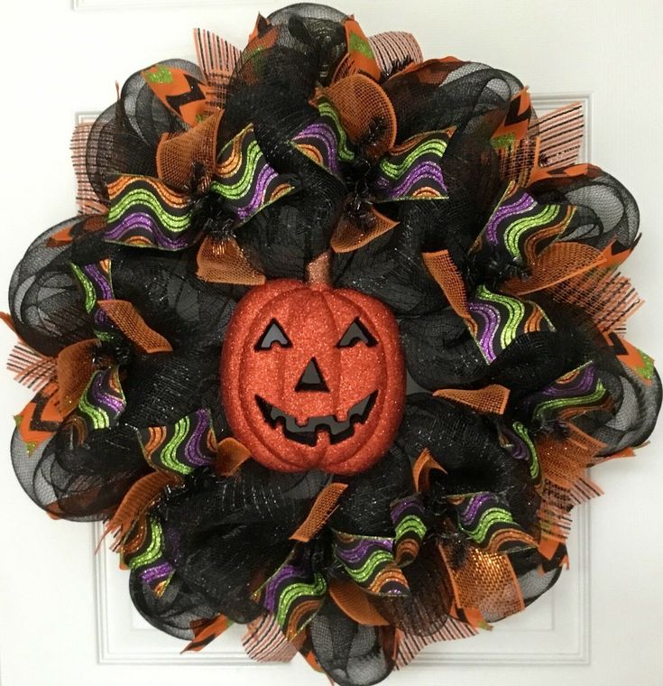 a halloween mesh wreath with a pumpkin on it