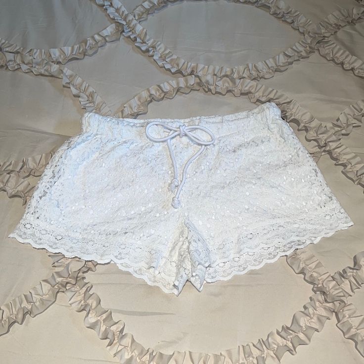 Nwt..White Lace Shorts With Elastic And Drawstring At The Waist, Fully Lined And Scalloped At Hemline Never Worn With No Pulls Or Rips From A Smoke Free Home. Would Be Great Over Swim Bottoms Or Cute With Any Top For The Summer Time Laying Flat - Waist Measures 16” Length 12” Inseam 3” Spring Lace Shorts For Loungewear, White Lace Beachwear Bottoms, Lace Bottoms For Beach, Short Length, Lace Beach Bottoms In Short Length, Lace Beach Bottoms Of Short Length, Lace Bottoms For Summer Loungewear, Lace Bottoms For Vacation, Short Length, Lace Summer Shorts For Vacation, Lace Bottoms For Beach Season Vacation