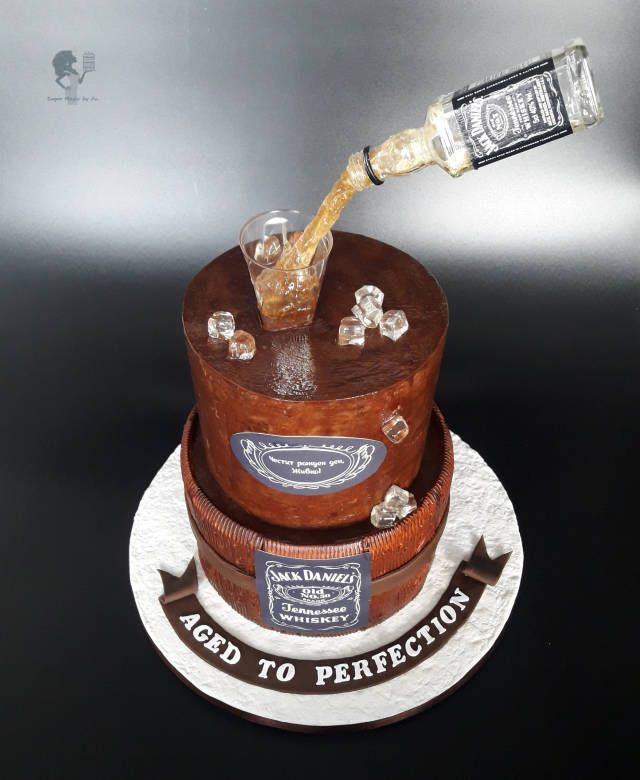 a cake made to look like an old whiskey bottle is being poured into the top