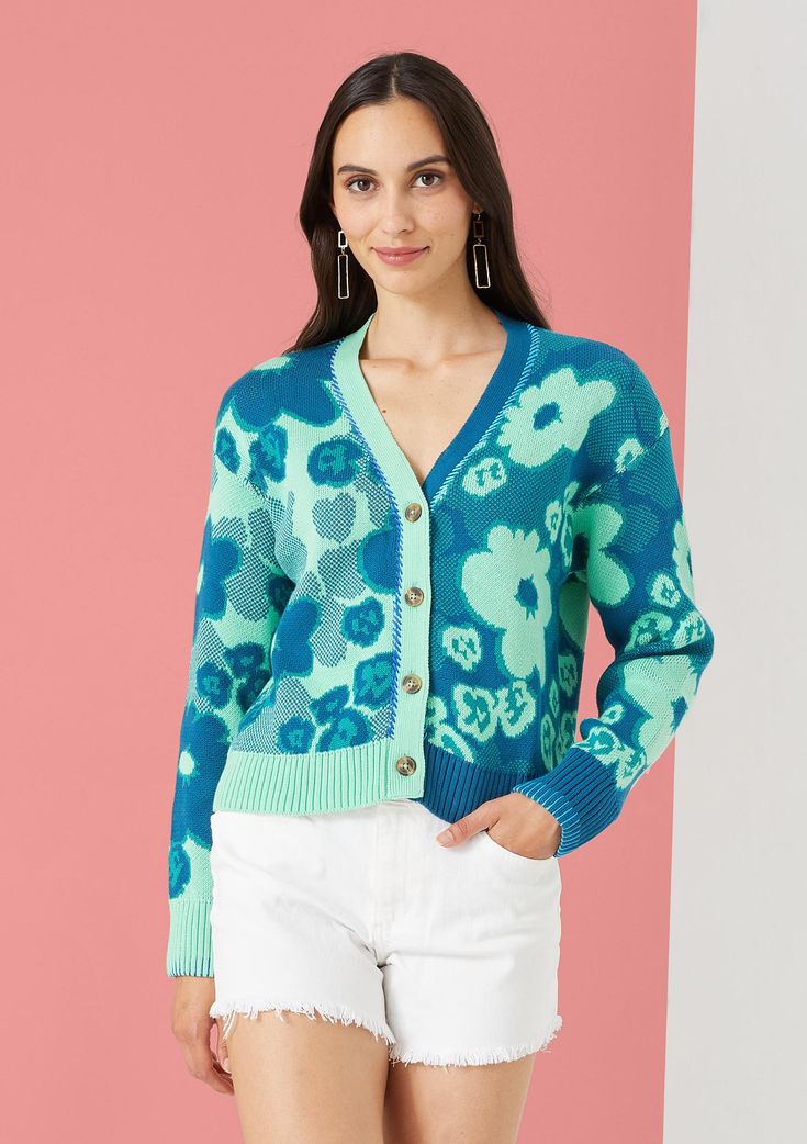 A split color jacquard cardigan designed to have a slightly cropped fit. Added contrast hand-embroidery around the neck and sleeves by artisans in India. Cotton Jacquard Knit V-neck Sweater, Fitted Jacquard Knit Cardigan, Spring Jacquard Knit Long Sleeve Cardigan, Green Jacquard Knit Sweater, Winter Floral Print Long Sleeve Cardigan, Spring Multicolor Jacquard Knit Cardigan, Trendy Spring Jacquard Knit Sweater, Multicolor Jacquard Knit Cardigan For Spring, Spring Trendy Jacquard Knit Sweater