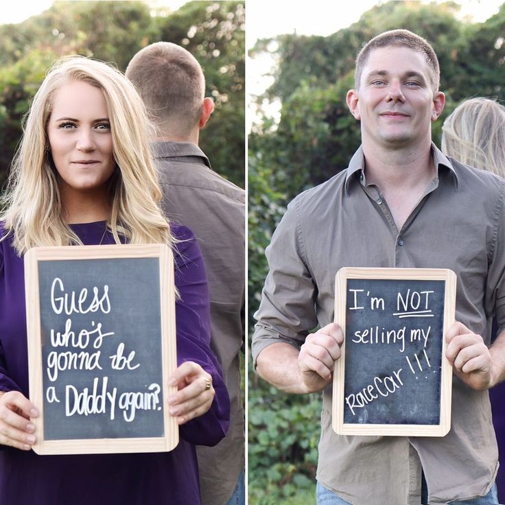 two people holding signs that say i'm not going to be a dad again