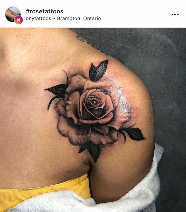 a woman's shoulder with a rose tattoo on it