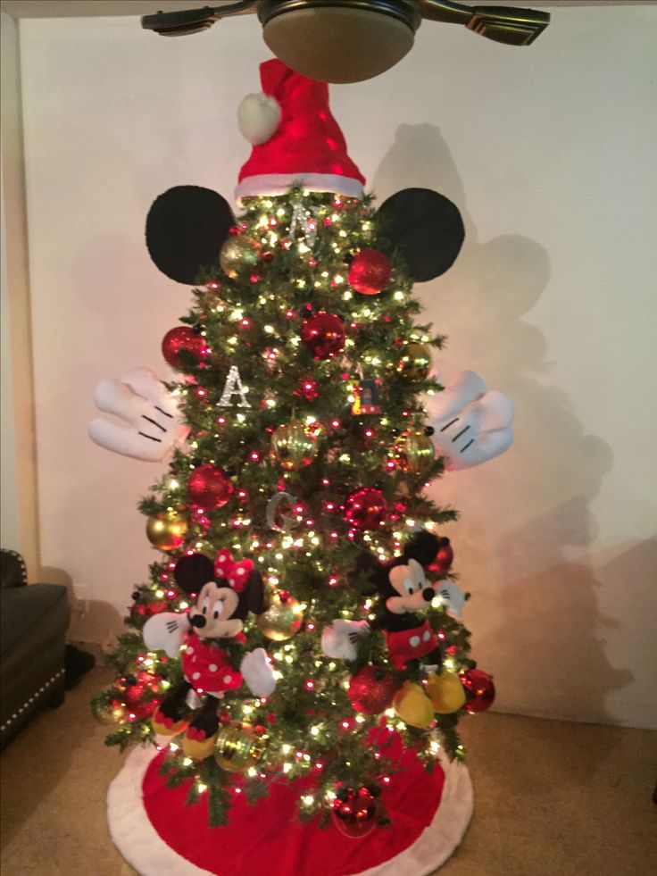 the christmas tree has mickey mouse decorations on it