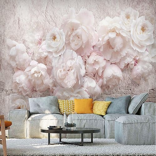 the living room is decorated with flowers on the wall