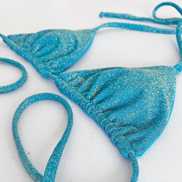 • Lightly Padded • Iridescent Beads • Ethically Made in the USA Swoon's triangle bikini top has the beautiful Emerald color with a touch of sparkle. Flip this bikini upside down to wear it with a different style.Ethically Made in the USA, our triangle bikini top is made from an amazing fabric that is so soft you'll want to wear it every day! The quality fabric has a shimmer that will glint in the sun, bringing out your inner mermaid.This top comes with padding for an enhanced fit and aesthetic appeal, as well as spaghetti straps for added comfort.In this bikini top you will look gorgeous on your next beach day or pool party. Emerald Color, Conscious Consumer, Ethical Fashion, We Wear, Upside Down, Pool Party, Beach Day, Quality Fabric, Spaghetti Strap