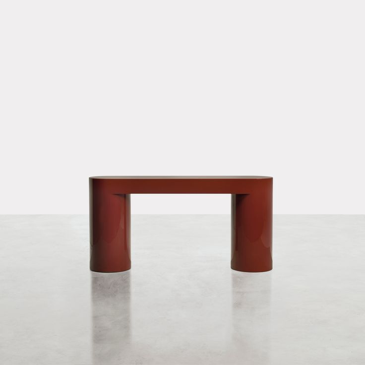 a red table sitting on top of a white floor