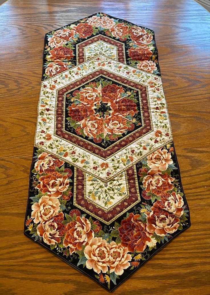 a large rug with flowers on it sitting on the floor