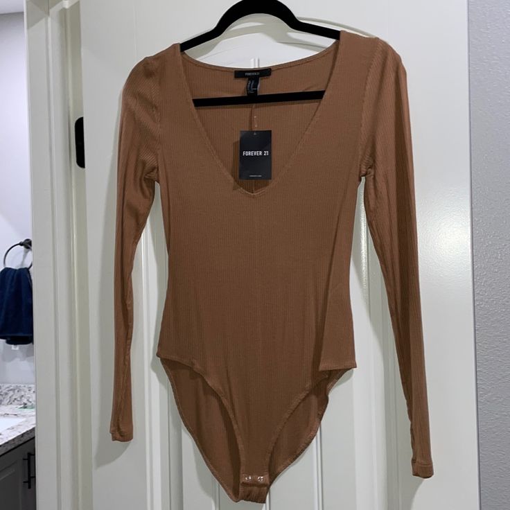 Forever 21 Nwt Brown Long Sleeve Bodysuit Trendy Brown Long Sleeve Bodysuit, Casual Brown Bodysuit For Spring, Casual Long Sleeve Bodysuit For Date Night, Trendy Brown Bodysuit For Spring, Trendy Brown Bodysuit For Night Out, Beige V-neck Bodysuit For Spring, Spring Beige V-neck Bodysuit, Trendy Beige Bodysuit For Spring, Trendy Beige Spring Bodysuit