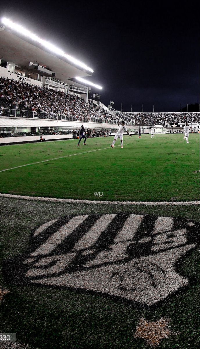 a soccer game is being played on the field in front of an empty bleachers