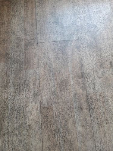 an image of a wood floor that looks like it has been cleaned and is very dirty