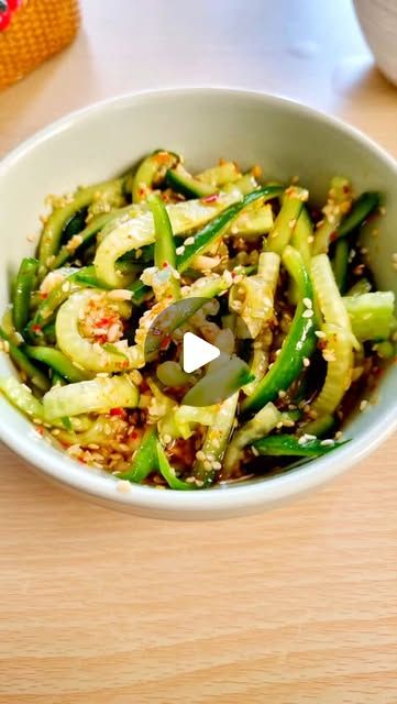 a white bowl filled with vegetables on top of a wooden table