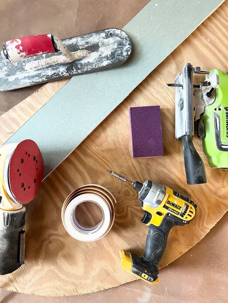 some tools are sitting on top of a wooden table