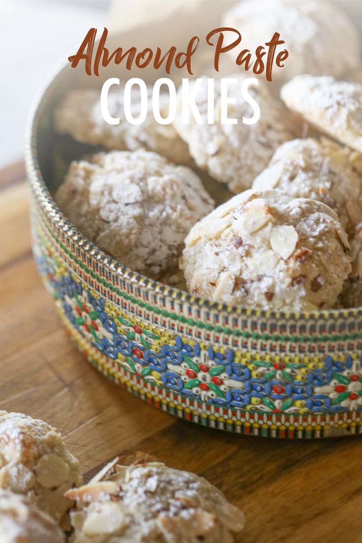 almond paste cookies in a colorful bowl on a wooden table with text overlay that reads, almond paste cookies